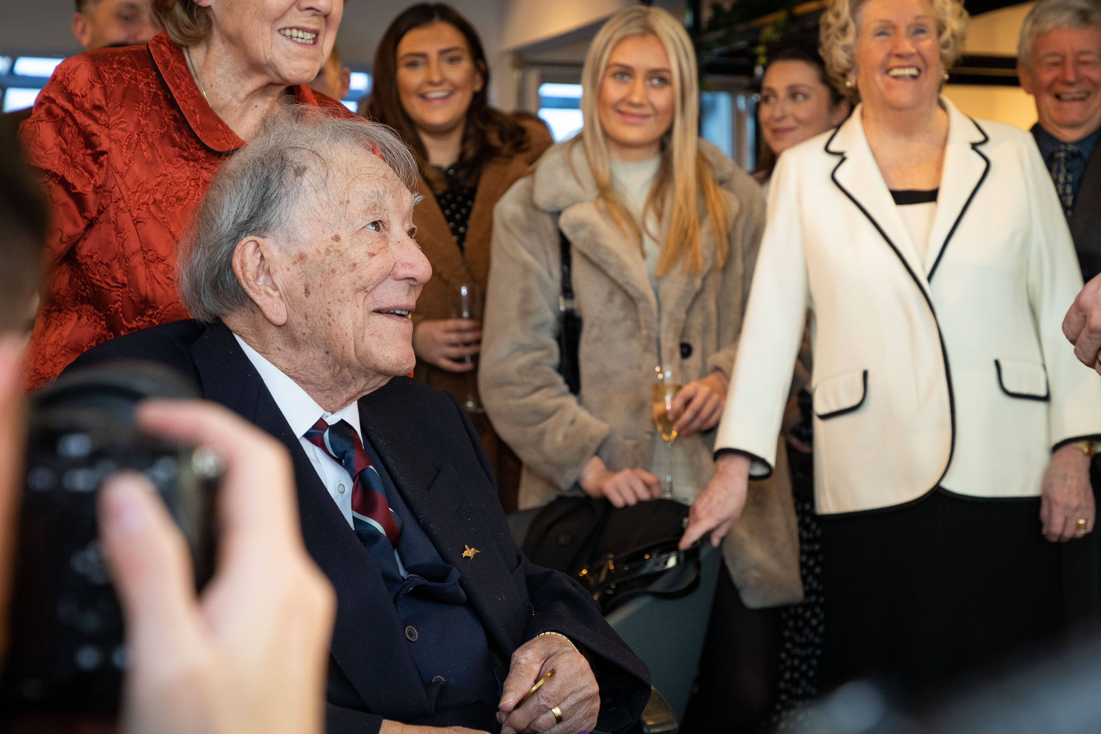 Image shows RAF veteran and civilians smiling.